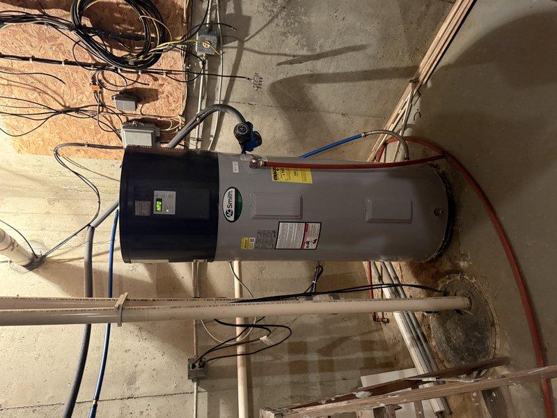 Diagnosed AO Smith hybrid water heater with non-functioning power display. Performed warranty-covered diagnostic inspection of temperature sensor, heating elements, and heat pump components as requested by manufacturer.
