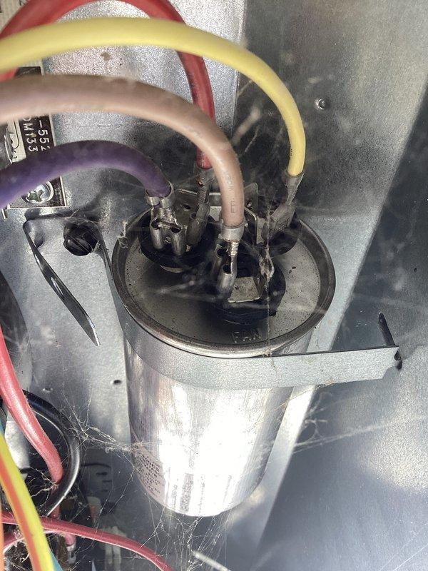 Responded to service call for non-functioning outdoor HVAC unit. Diagnosed failed capacitor as evidenced by system operation in emergency heat mode with thermostat displaying "EmHeat 68." Replaced capacitor, restoring normal system operation and cooling functionality.