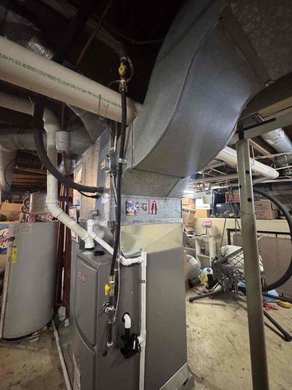 Completed installation of a Lennox gas furnace in basement utility area with proper connection to existing ductwork system. Installed PVC ventilation components and connected gas lines with appropriate valves for safe operation.