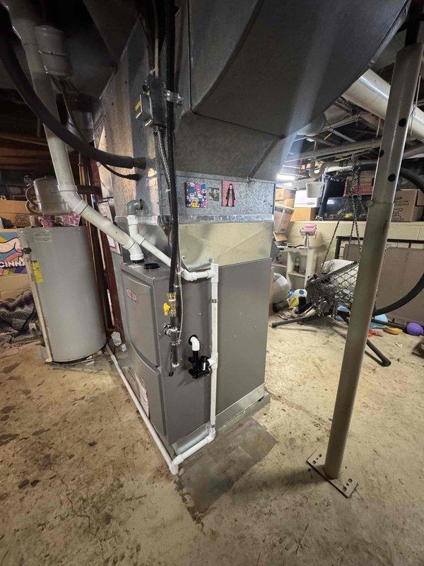 Completed installation of a Lennox gas furnace in basement utility area with proper connection to existing ductwork system. Installed PVC ventilation components and connected gas lines with appropriate valves for safe operation.