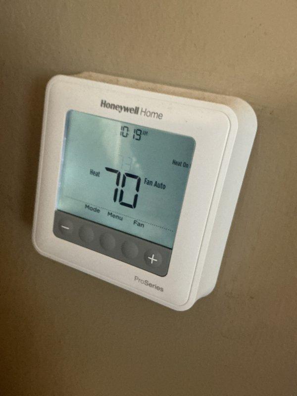 Performed annual heating maintenance service on CCHP-Heating system (renewal 5/20/26). Inspected Honeywell ProSeries thermostat confirming proper operation in heat mode with fan auto setting. Examined furnace internal components and replaced filter, noting system is functioning normally with no issues detected.