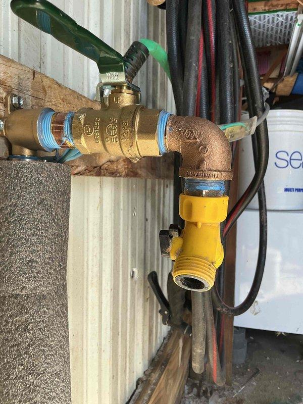 Responded to warranty service for a slow water leak at brass fitting installation. Inspected the brass shutoff valve assembly with copper elbow connection where approximately 4-5 gallons of water had leaked from the sealed connection. Applied appropriate sealing measures to resolve the dripping issue at the brass fitting connection point.