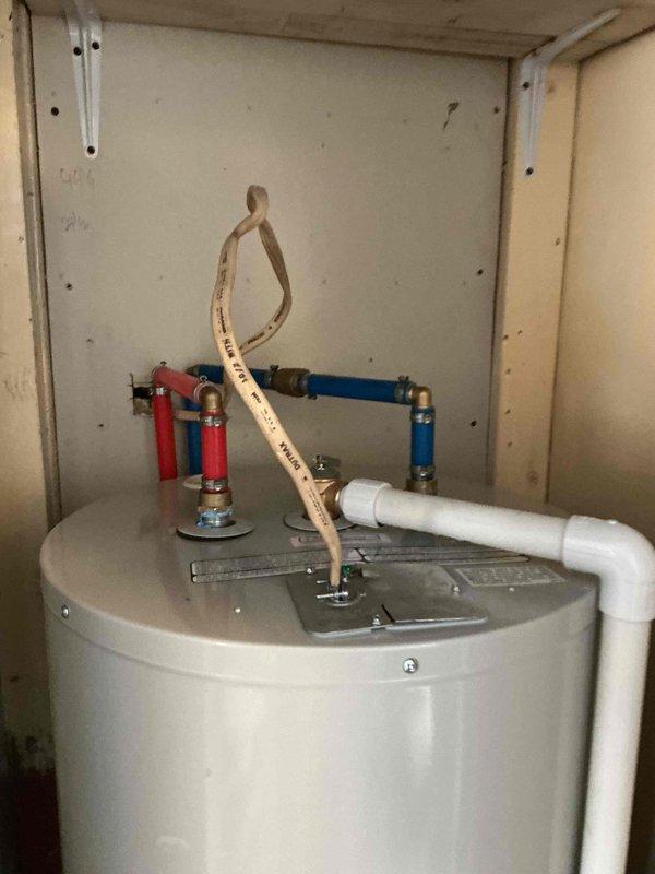 Responded to service call for frozen pipes and leaking water heater. Upon inspection, discovered copper supply lines to water heater had frozen and created minor leakage at connection points. Thawed affected pipes using controlled heat application, replaced damaged section of copper piping, and installed new valve assembly. Verified water heater operation and confirmed no additional leaks present after repair.