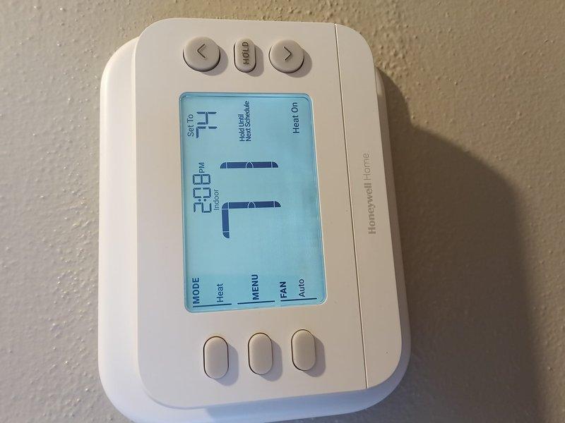 Completed installation of new heating system with Honeywell Home digital thermostat. Verified proper thermostat operation in heat mode with display showing correct temperature readings. System successfully powered up and functioning as designed.