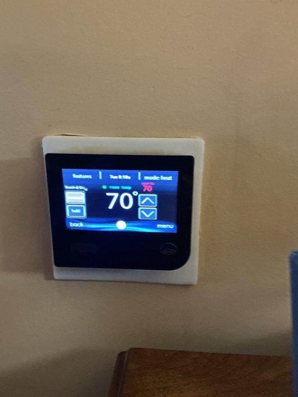 Performed monthly maintenance service on the CCHP heating system with inspection of the 20x20 Infinity Air purifier. Checked the programmable thermostat for proper operation and temperature control functionality. Accessed and examined interior components of the heating unit, including coils and connections, noting some dust accumulation requiring cleaning.