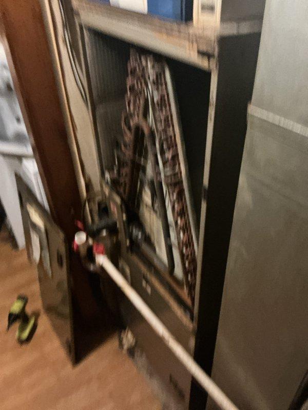 Performed monthly maintenance service on the CCHP heating system with inspection of the 20x20 Infinity Air purifier. Checked the programmable thermostat for proper operation and temperature control functionality. Accessed and examined interior components of the heating unit, including coils and connections, noting some dust accumulation requiring cleaning.