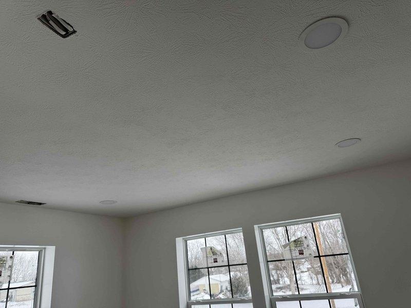 Completed rough-in electrical installation for new construction, including recessed can lights, outlets, and vanity lighting. All fixtures properly positioned and secured in textured ceiling as per specifications. Work is complete and ready for inspection.