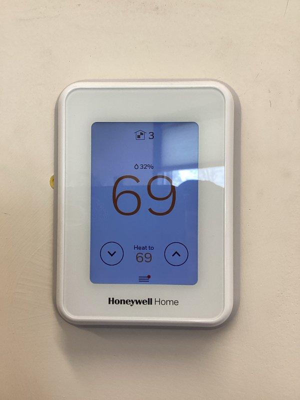 Responded to service call regarding non-functioning dampers. Accessed attic to inspect HVAC system, which consists of dual furnace units with extensive PVC ventilation network. Verified thermostat functionality (Honeywell Home digital display showing proper temperature and humidity readings). Trip fee waived per office authorization.