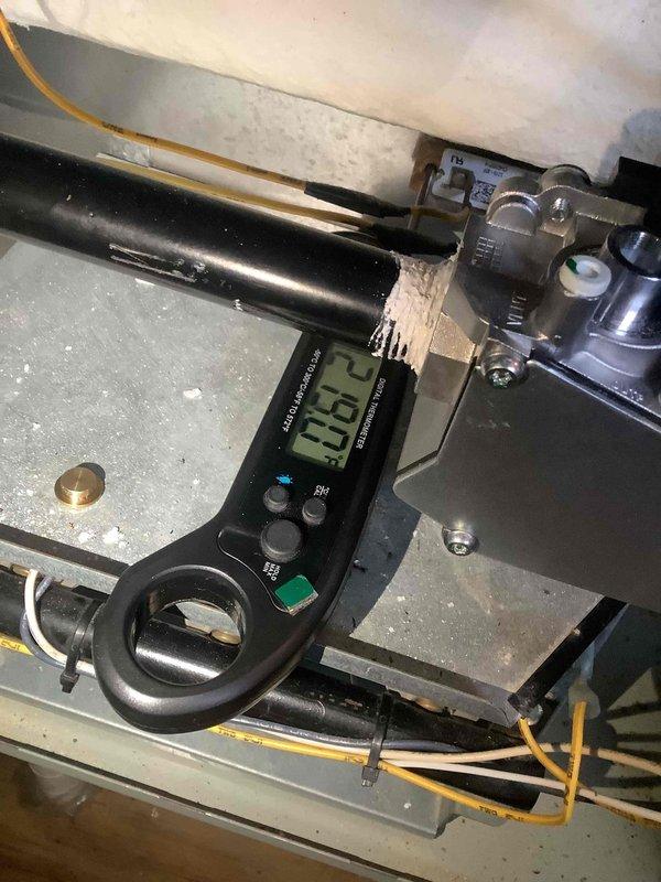 Performed diagnostic assessment on furnace system, identifying issues requiring service. Conducted electrical measurements with clamp meter, recording amperage reading of 38.2. Inspected interior components including copper refrigerant lines and heat exchanger for proper operation and condition.