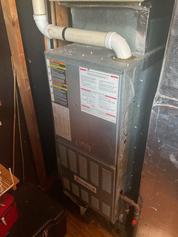 Performed second opinion evaluation on customer's planned furnace replacement. Inspected existing aging furnace unit with standard PVC venting system and examined outdoor condenser/heat pump showing signs of weathering and debris accumulation. Customer has already placed deposit with another company for new system installation scheduled for Monday.