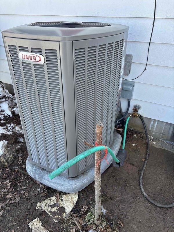 Completed installation of new Lennox HVAC system, including outdoor condenser unit properly mounted on concrete pad with all necessary refrigerant lines and electrical connections. System was fully tested with temperature verification showing proper operation at 75.7°F. Customer financing documentation was completed and identification verified.