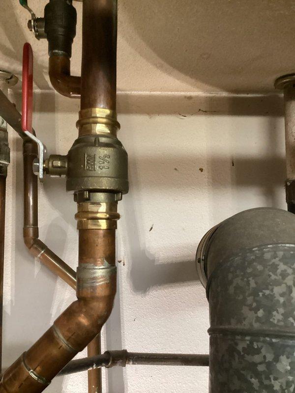 Responded to water leak service call and identified leak at copper T-joint connection near water heater. Repaired damaged section by replacing corroded copper pipe fitting and tested system to ensure proper operation with no further leakage.