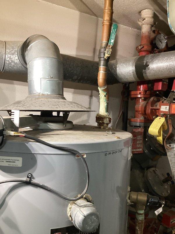 Responded to water leak service call and identified leak at copper T-joint connection near water heater. Repaired damaged section by replacing corroded copper pipe fitting and tested system to ensure proper operation with no further leakage.