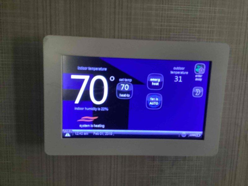 Performed diagnostic service on heat pump system exhibiting ice buildup approximately one-third up the outdoor unit with visible panel displacement. Inspection revealed defrost cycle malfunction preventing proper ice removal. Cleared accumulated ice, restored proper defrost operation, and verified system functionality. Indoor temperature maintained at 70°F with 25% humidity while outdoor temperature was 31°F.