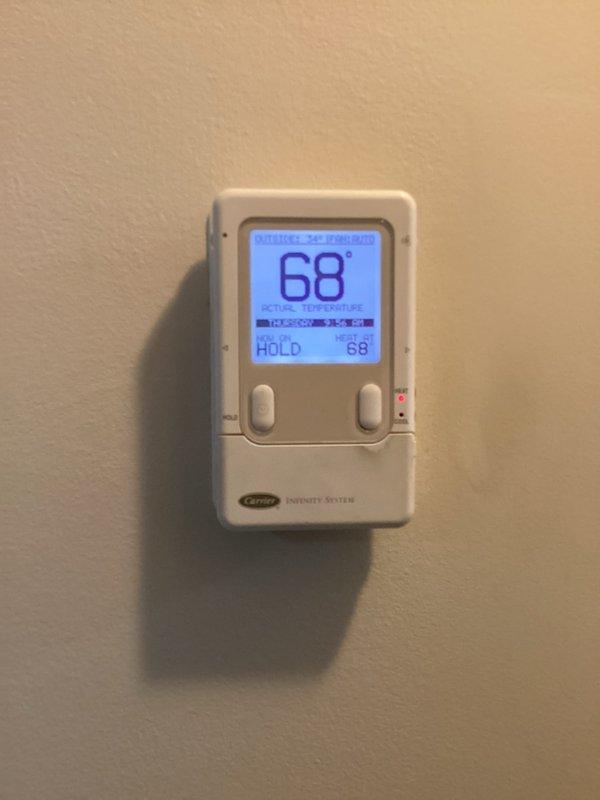 Completed monthly basic maintenance service on Carrier heating system. Inspected outdoor unit and verified proper operation of Carrier Infinity thermostat, which was functioning correctly at 68°F on hold mode. Electronic air cleaner filter not included in this service.