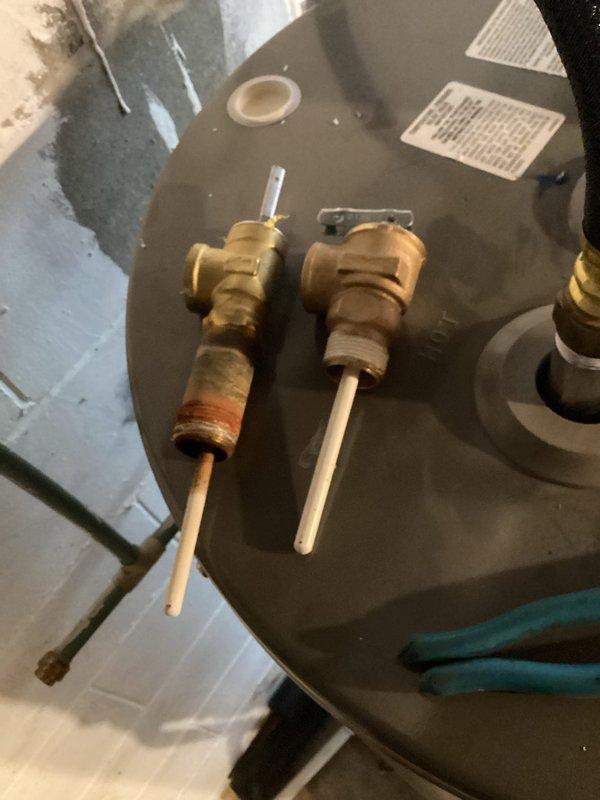 Responded to service call for water heater leaking from pressure relief valve. Inspected unit and found evidence of valve corrosion. Replaced temperature and pressure relief valve to resolve the dripping issue. Unit now functioning properly with no leaks observed.