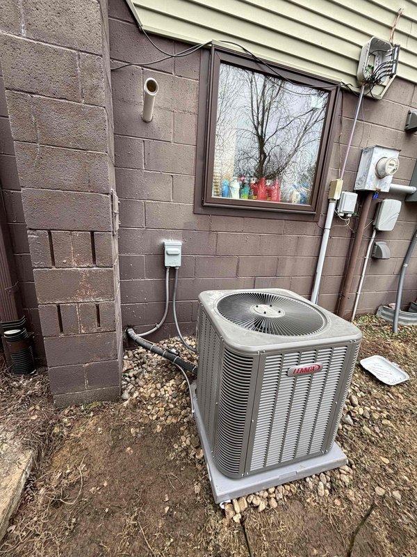 Successfully installed a complete Lennox AC and gas furnace system at the client's residence. Positioned the Lennox condenser unit on a properly prepared gravel base alongside the building's exterior wall, ensuring proper clearance and accessibility. System startup verified optimal performance with discharge temperature reading 119.3°F as measured with Klein Tools digital thermometer.