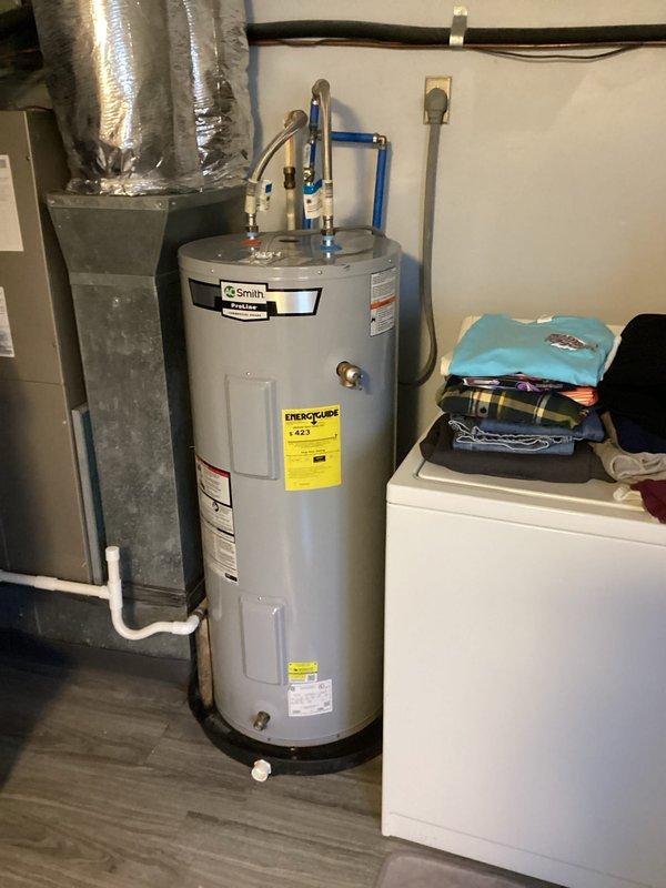 Performed monthly basic heating maintenance service at residence. Inspected Honeywell thermostat confirming proper operation in heat mode with temperature set at 68°F and fan in auto mode. Visual examination of heating system showed proper installation with appropriate ductwork and connections to water heater system.