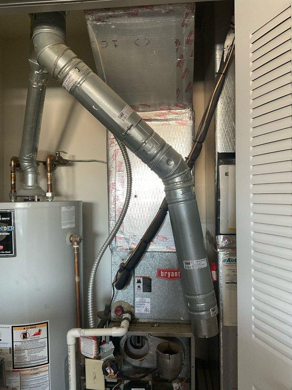 Conducted a comprehensive evaluation of aging Bryant HVAC system to provide replacement options after previous technician determined the inducer motor was unavailable due to system age. Documented existing installation including furnace unit, ductwork configuration, and adjacent water heater to prepare accurate replacement estimate for full system upgrade. Customer requires urgent installation timeline.