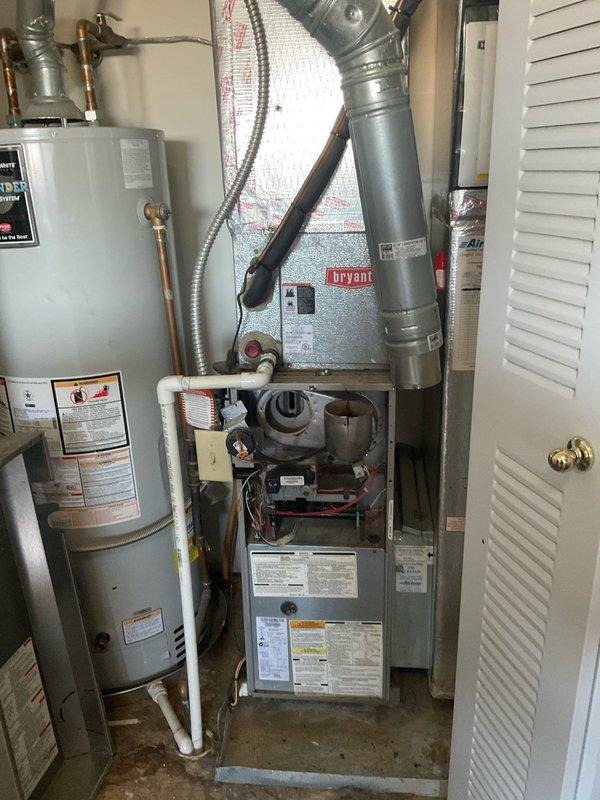 Conducted a comprehensive evaluation of aging Bryant HVAC system to provide replacement options after previous technician determined the inducer motor was unavailable due to system age. Documented existing installation including furnace unit, ductwork configuration, and adjacent water heater to prepare accurate replacement estimate for full system upgrade. Customer requires urgent installation timeline.
