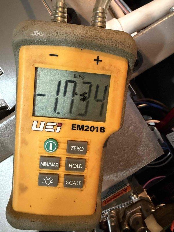 Completed installation of a complete Lennox HVAC system, including outdoor AC unit and gas furnace. System was properly mounted on concrete pad with electrical connections secured. Verified proper system pressure readings using UEI EM201B meter, with documentation of -17.34 In-Wg measurement during commissioning.