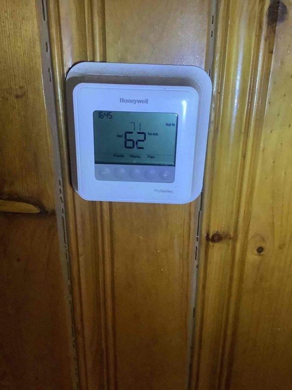 Diagnosed HVAC system issue by inspecting Honeywell ProSeries thermostat and furnace unit. Found system operating at 62 degrees, below setpoint, with all furnace components appearing in normal working condition upon visual inspection of internal components, wiring, motor and ductwork connections.