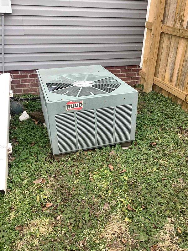 Performed diagnostic assessment on Ruud HVAC system, identifying moisture issues near the furnace base with visible staining on the floor. Inspected internal components including control boards, wiring, and heating elements, along with examining the condensate drain line which appears to be the source of the moisture problem. Noted outdoor condenser unit requires vegetation management around its perimeter for optimal airflow.
