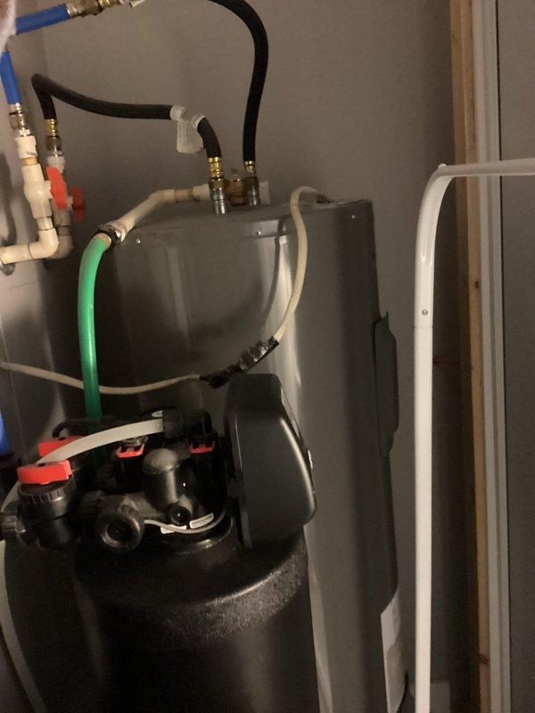 Performed complimentary tune-up service as part of maintenance plan enrollment. Inspected pressure vessel system with multiple connection points, verifying proper installation of PVC pipes and hose connections. Checked Lennox smart thermostat operation, confirming proper heat mode functionality with set point at 68° and current reading at 66°.