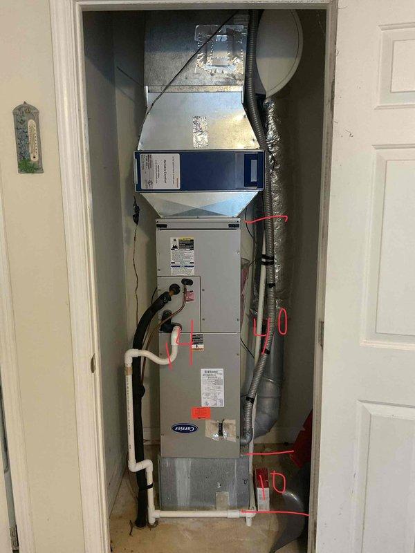 Diagnosed 2011 Carrier heat pump system with significant refrigerant loss. Documented current installation configuration in utility closet, noting proper ductwork connections and condensate drainage. Recommended full system replacement due to age of unit and R410A refrigerant requirements.