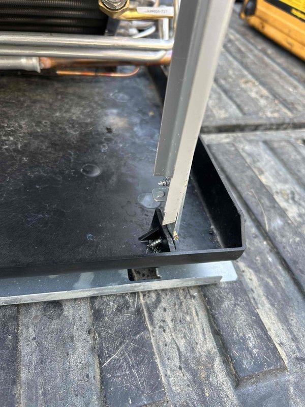 Successfully replaced evaporator coil in cabin-style residence with wood-paneled interior. Equipment was properly installed in the mechanical area visible through an opening in the wall, with all connections secured and tested.