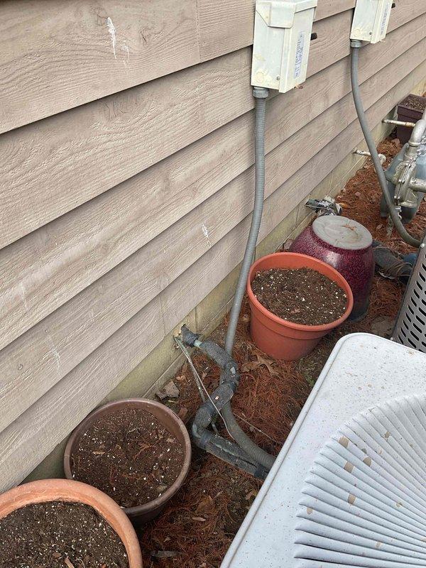 Inspected 38-year-old non-operational HVAC system in customer's newly purchased condo. System is original to the property and requires full replacement due to age and failure. Documented current installation including furnace unit with HSC branding and associated ductwork, ventilation, and exterior components.