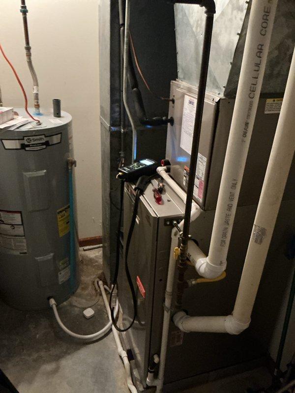 Completed scheduled maintenance on a residential heating system, which included inspection of the A.O. Smith electric water heater (Model ERS-50 110) and furnace unit. Connected diagnostic tool to furnace to verify proper operation parameters and inspected ventilation components including PVC cellular core piping.