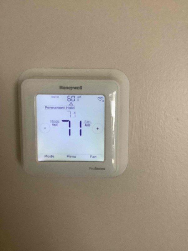 Responded to no-heat call for furnace that would not activate. Inspected thermostat (Honeywell ProSeries) which displayed 60°F current temperature with 71°F setpoint in Permanent Hold mode. Connected test and charging manifold to diagnose system operation. Identified and resolved issue, restoring proper heating function.