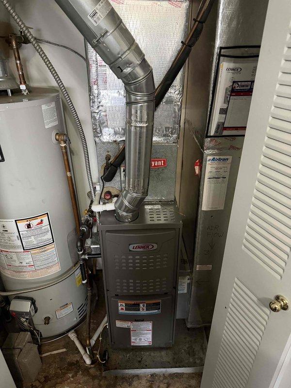 Installed new Lennox 80% efficiency furnace in residential utility closet, connecting to existing ductwork with proper 90-degree elbow joints and ensuring proper airflow direction. Temperature verification testing confirmed optimal system operation with readings of 127.9°F at heat exchanger output.