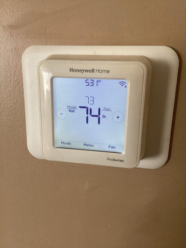 Performed annual maintenance on heating system, cleaning blower wheel assembly to remove dust buildup and ensure proper airflow. Tested Honeywell Home ProSeries thermostat operation, confirming proper heat mode function with temperature reading at 73°F and set point at 74°F. System functioning normally with fan operating as expected.