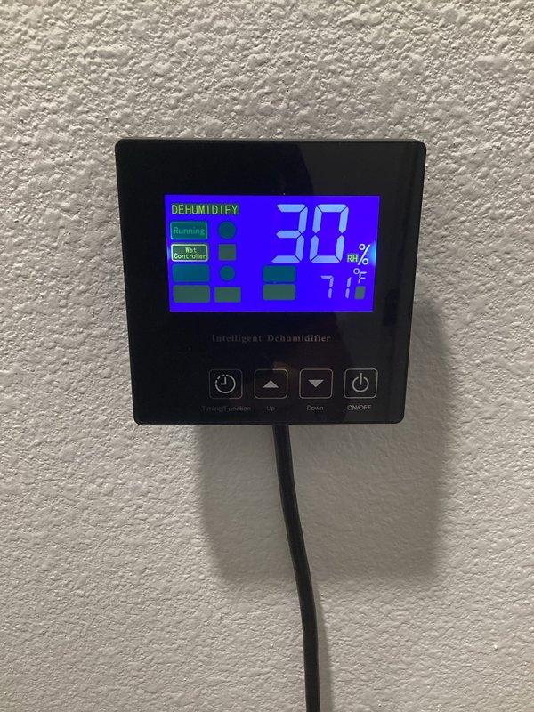 Responded to service call regarding excessive moisture concerns in home. Inspected intelligent dehumidifier system which was actively running at 30% relative humidity setting with ambient temperature reading 71°F. Verified proper operation of ecobee thermostat showing 74°F with 43% humidity level.