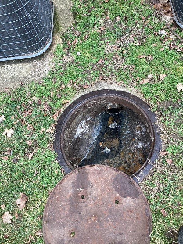 Responded to commercial plumbing service call for water backing up into unit. Accessed outdoor sewer cleanout and found significant debris accumulation and root intrusion in the drainage system. Successfully cleared blockage, restoring proper drainage function and preventing further water backup issues.