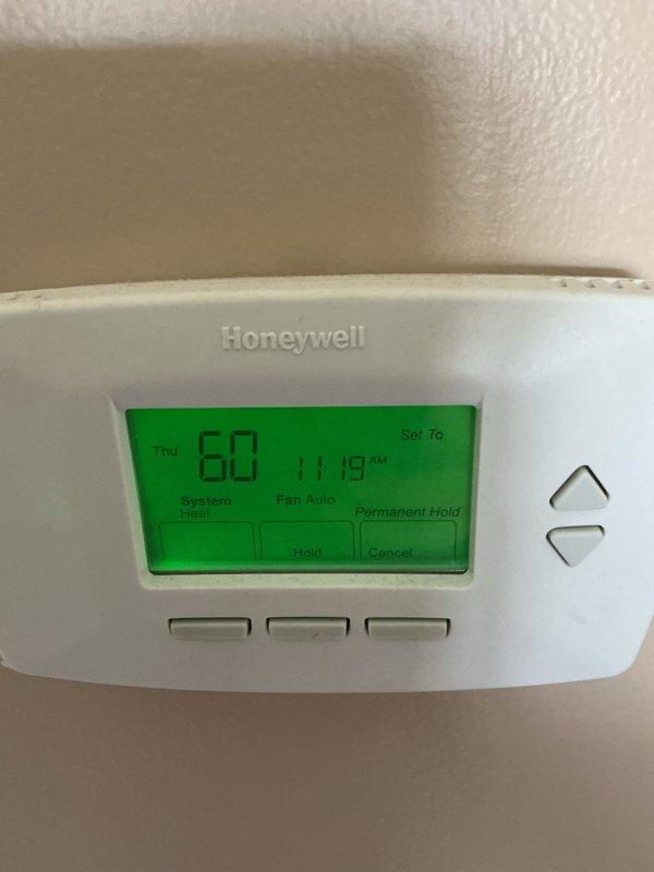 Performed basic monthly maintenance on central heating system. Inspected Honeywell thermostat which was functioning properly and set to 60°F heat mode. Examined outdoor condenser unit which showed no visible damage or issues; unit properly mounted on concrete pad with all connections intact.