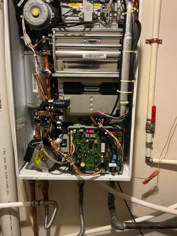 Responded to service call for intermittent heating issues with a Navien tankless water heater at the Yellow House. Diagnostic inspection revealed error code E-105 displayed on the unit's circuit board. Performed comprehensive system check, cleaned internal components, and verified proper operation of heating elements and flow sensors to resolve the intermittent heating problem.