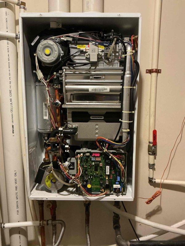 Responded to service call for intermittent heating issues with a Navien tankless water heater at the Yellow House. Diagnostic inspection revealed error code E-105 displayed on the unit's circuit board. Performed comprehensive system check, cleaned internal components, and verified proper operation of heating elements and flow sensors to resolve the intermittent heating problem.