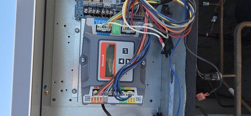 Returned to site to install customer-provided control board and gas valve as scheduled. Accessed HVAC control system, disconnected and carefully labeled multiple wire connections from existing Honeywell control unit with digital display. Completed installation of new components, ensuring proper wire terminations to all connection points on the circuit board and control assembly. System tested operational after repair.