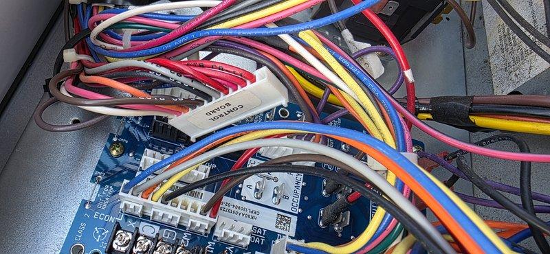 Returned to site to install customer-provided control board and gas valve as scheduled. Accessed HVAC control system, disconnected and carefully labeled multiple wire connections from existing Honeywell control unit with digital display. Completed installation of new components, ensuring proper wire terminations to all connection points on the circuit board and control assembly. System tested operational after repair.