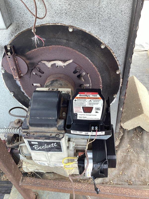 Performed diagnostic evaluation and repair on oil furnace system. Replaced failed Beckett burner assembly and installed new Emerson digital thermostat in greenhouse environment. System successfully tested with proper temperature regulation restored to 99°F for optimal plant cultivation conditions.