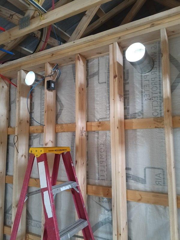 Completed installation of ERV intake and exhaust systems in new commercial construction during rough-in phase. Successfully ran thermostat wiring to indoor unit through exposed framing. All work performed according to specifications with proper integration into the existing wooden structural framework.