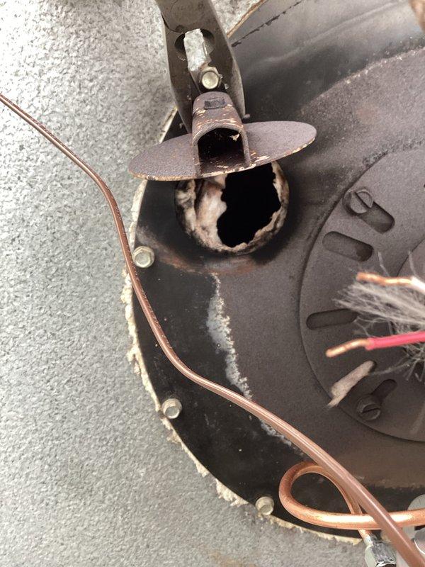 Diagnosed oil furnace leak occurring at air tube assembly during operation. Inspection revealed significant burn-through damage on the air tube component of the Beckett oil burner. Recommended replacement of air tube, nozzle, and orifice assembly to resolve oil leakage issue at the burner.