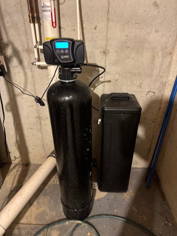 Responded to service call for a Smith ProLine XE tanked water heater located in basement utility area. Performed diagnostic assessment of unit and surrounding water treatment system, which included a Durawater filtration system with digital control head and brine tank. Completed necessary maintenance and repairs to restore proper water heater functionality.
