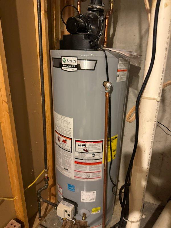 Responded to service call for a Smith ProLine XE tanked water heater located in basement utility area. Performed diagnostic assessment of unit and surrounding water treatment system, which included a Durawater filtration system with digital control head and brine tank. Completed necessary maintenance and repairs to restore proper water heater functionality.
