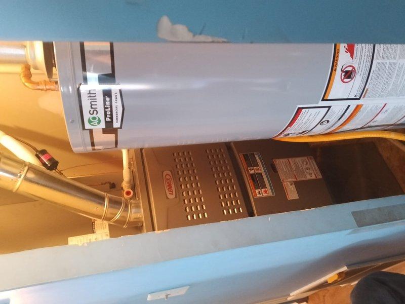 Successfully installed a new Lennox 80% efficient gas furnace in the utility area adjacent to the existing Smith ProLine water heater. System was properly connected to existing ductwork and gas lines, with temperature testing confirming proper operation at 117.6°F. All manufacturer specifications were followed and system is functioning as designed.