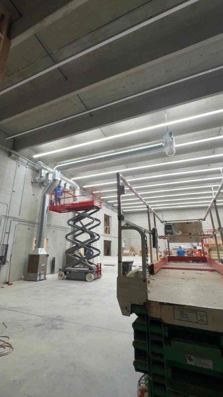 Completed installation of spiral ductwork for Fortress project. Utilized scissor lift to access ceiling areas for proper duct mounting and connections. Verified alignment of HVAC pathways with building framing to ensure optimal airflow in the commercial space.