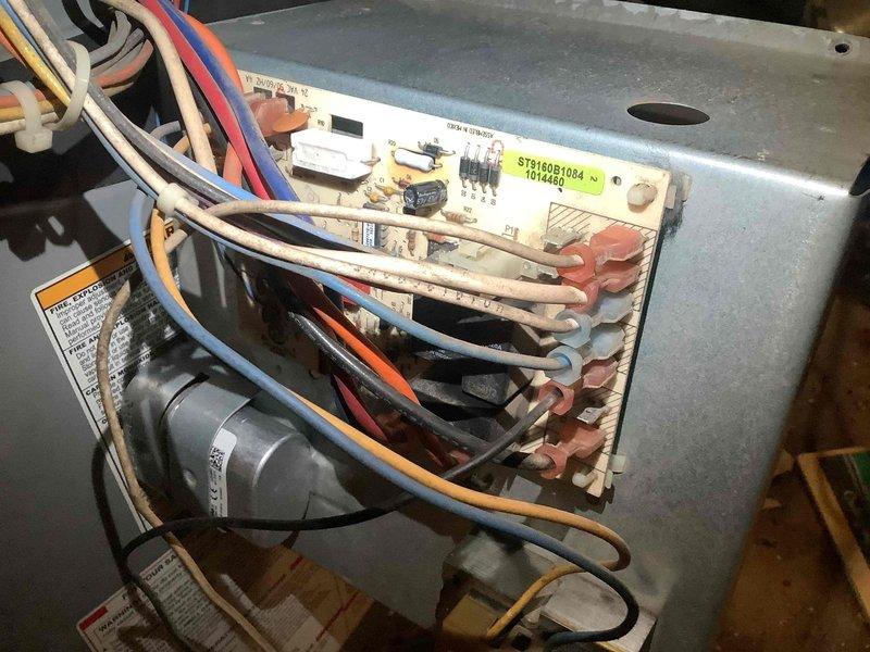 Performed OEM blower motor repair on HVAC system. Accessed control board (ST916081094) with visible dust accumulation and inspected wiring connections to the motor. Completed necessary repairs to restore proper system operation.